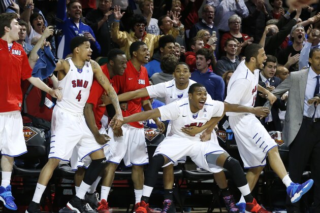 The SMU bench, including guard Keith Frazier (4), guard Sterling Brown (3) and center Cannen Cunningham (15), celebrates just before time expired in an NCAA college basketball game against California in the quarterfinals of the NIT, Wednesday, March 26, 2014, in Dallas. SMU won 67-65. (AP Photo/Sharon Ellman)