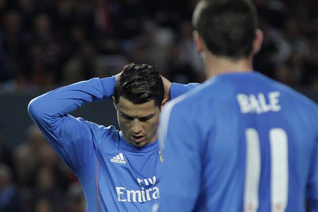 Real Madrid's Cristiano Ronaldo, left, from Portugal reacts during a La Liga soccer match against Sevilla at the Ramon Sanchez Pizjuan stadium, in Seville, Spain on Wednesday, March 26, 2014. (AP Photo/Angel Fernandez)