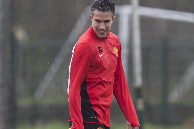 Manchester United's Robin van Persie smiles as he trains with teammates at Carrington training ground in Manchester, Tuesday, March 18, 2014. Manchester United will play Olympiakos in a Champions League last 16 second leg soccer match on Wednesday. (AP Photo/Jon Super)
