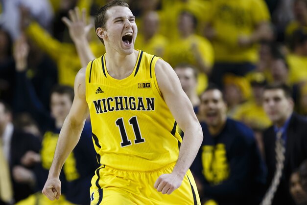 Feb 23, 2014; Ann Arbor, MI, USA; Michigan Wolverines guard Nik Stauskas (11) celebrates against the Michigan State Spartans in the second half at Crisler Arena. Michigan 79-70. Mandatory Credit: Rick Osentoski-USA TODAY Sports