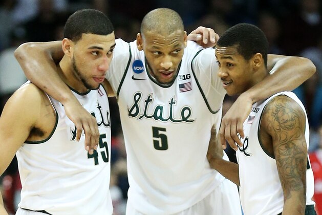 SPOKANE, WA - MARCH 22:  Denzel Valentine #45 Adreian Payne #5 and Keith Appling #11 of the Michigan State Spartans celebrate in the second half of their 80 to 73 win over the Harvard Crimson during the Third Round of the 2014 NCAA Basketball Tournament at Spokane Veterans Memorial Arena on March 22, 2014 in Spokane, Washington.  (Photo by Stephen Dunn/Getty Images)