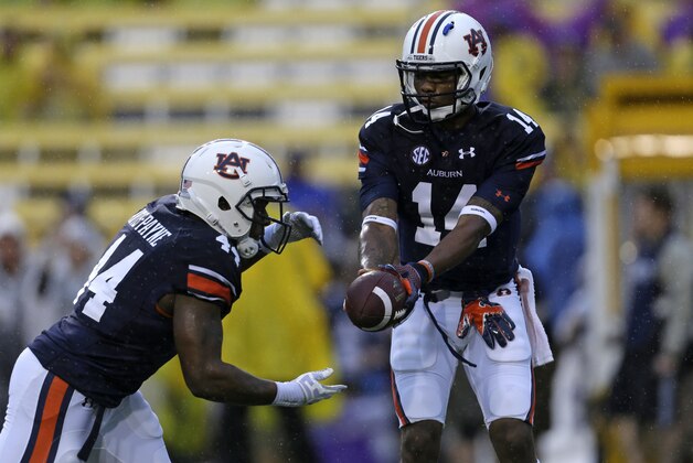 Auburn quarterback Nick Marshall (14) and running back Cameron Artis-Payne (44) warm up before an NCAA college football game against LSU in Baton Rouge, La., Saturday, Sept. 21, 2013. (AP Photo/Gerald Herbert) Auburn quarterback Nick Marshall (14) and running back Cameron Artis-Payne (44) warm up before an NCAA college football game against LSU in Baton Rouge, La., Saturday, Sept. 21, 2013. (AP Photo/Gerald Herbert)