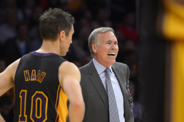 Los Angeles Lakers head coach Mike D'Antoni, right, yells at referees as guard Steve Nash looks on during the second half of an NBA basketball game against the Washington Wizards, Friday, March 21, 2014, in Los Angeles. The Wizards won 117-107. (AP Photo/Mark J. Terrill)