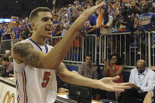 Florida guard Scottie Wilbekin (5) does the gator chomp as he leaves the court after Florida defeated LSU 79-61 in an NCAA college basketball game Saturday, March 1, 2014 in Gainesville, Fla.  (AP Photo/Phil Sandlin)