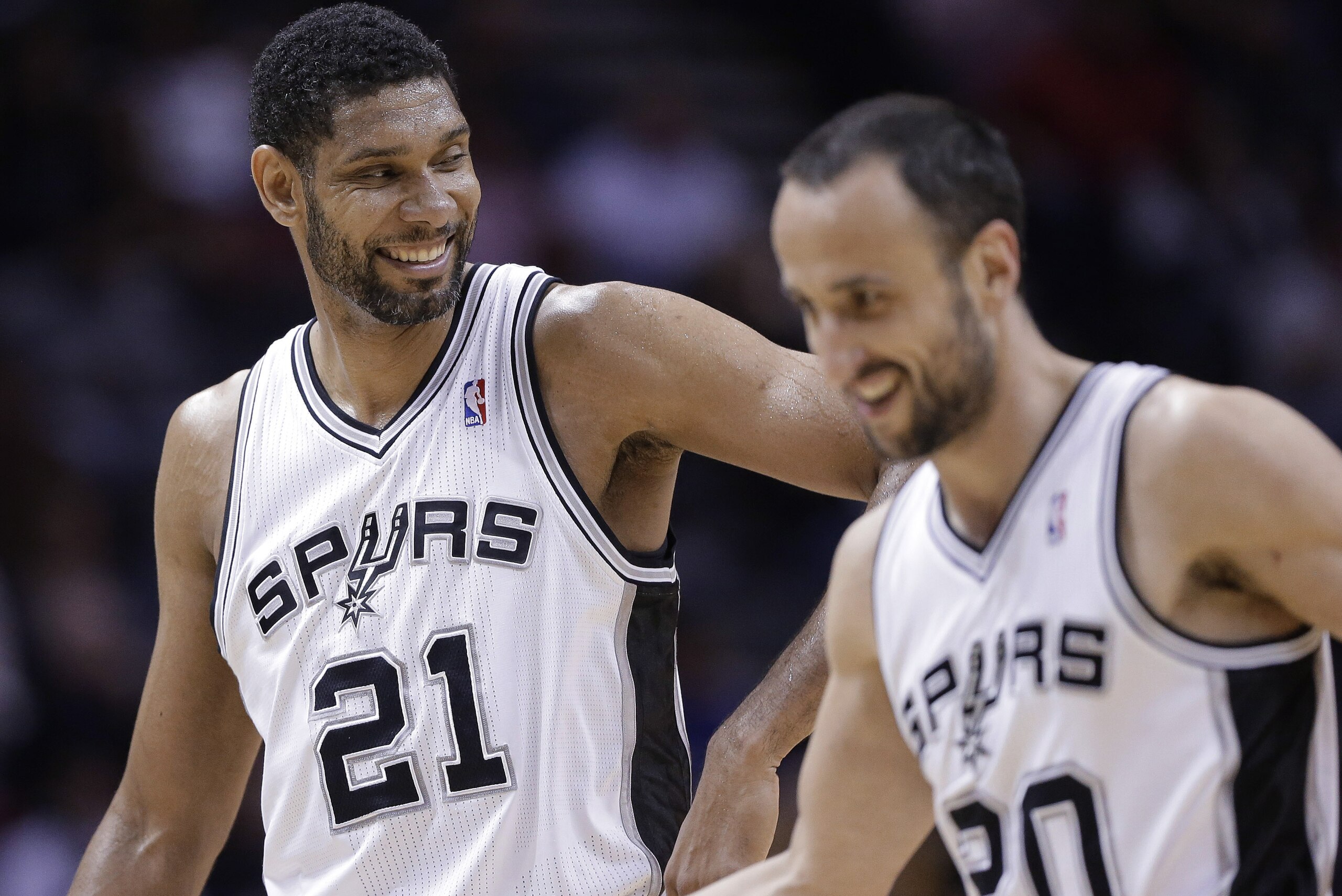 San Antonio Spurs' Tim Duncan (21) celebrates with Manu Ginobili (20) during the second half of an NBA basketball game against the Denver Nuggets, Wednesday, March 26, 2014, in San Antonio. San Antonio won 108-103. (AP Photo/Eric Gay) San Antonio Spurs' Tim Duncan (21) celebrates with Manu Ginobili (20) during the second half of an NBA basketball game against the Denver Nuggets, Wednesday, March 26, 2014, in San Antonio. San Antonio won 108-103. (AP Photo/Eric Gay)