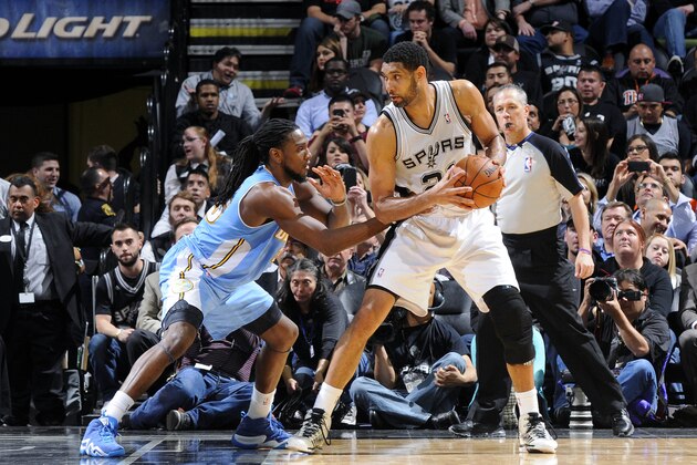 SAN ANTONIO, TX - March 26: Tim Duncan #21 of the San Antonio Spurs handles the ball against Kenneth Faried #35 of the Denver Nuggets at the AT&T Center on March 26, 2014 in San Antonio, Texas. NOTE TO USER: User expressly acknowledges and agrees that, by downloading and or using this photograph, user is consenting to the terms and conditions of the Getty Images License Agreement. Mandatory Copyright Notice: Copyright 2014 NBAE (Photos by D. Clarke Evans/NBAE via Getty Images)