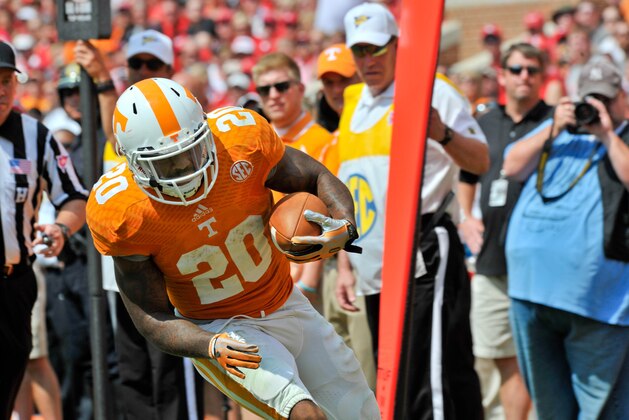 Sep 7, 2013; Knoxville, TN, USA; Tennessee Volunteers running back Rajion Neal (20) runs the val against the Western Kentucky Hilltoppers during the second half at Neyland Stadium. Tennessee won 52-20. Mandatory Credit: Jim Brown-USA TODAY Sports