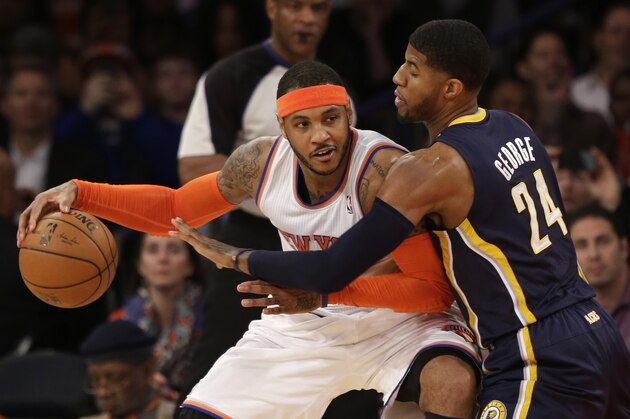 New York Knicks' Carmelo Anthony, left, tries to move around Indiana Pacers' Paul George during the first half of an NBA basketball game at Madison Square Garden on Wednesday, March 19, 2014, in New York. (AP Photo/Seth Wenig)
