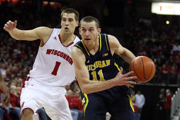 Jan 18, 2014; Madison, WI, USA; Michigan Wolverines guard Nik Stauskas (11) looks to shoot as Wisconsin Badgers guard Ben Brust (1) defends during the first half at the Kohl Center. Mandatory Credit: Mary Langenfeld-USA TODAY Sports