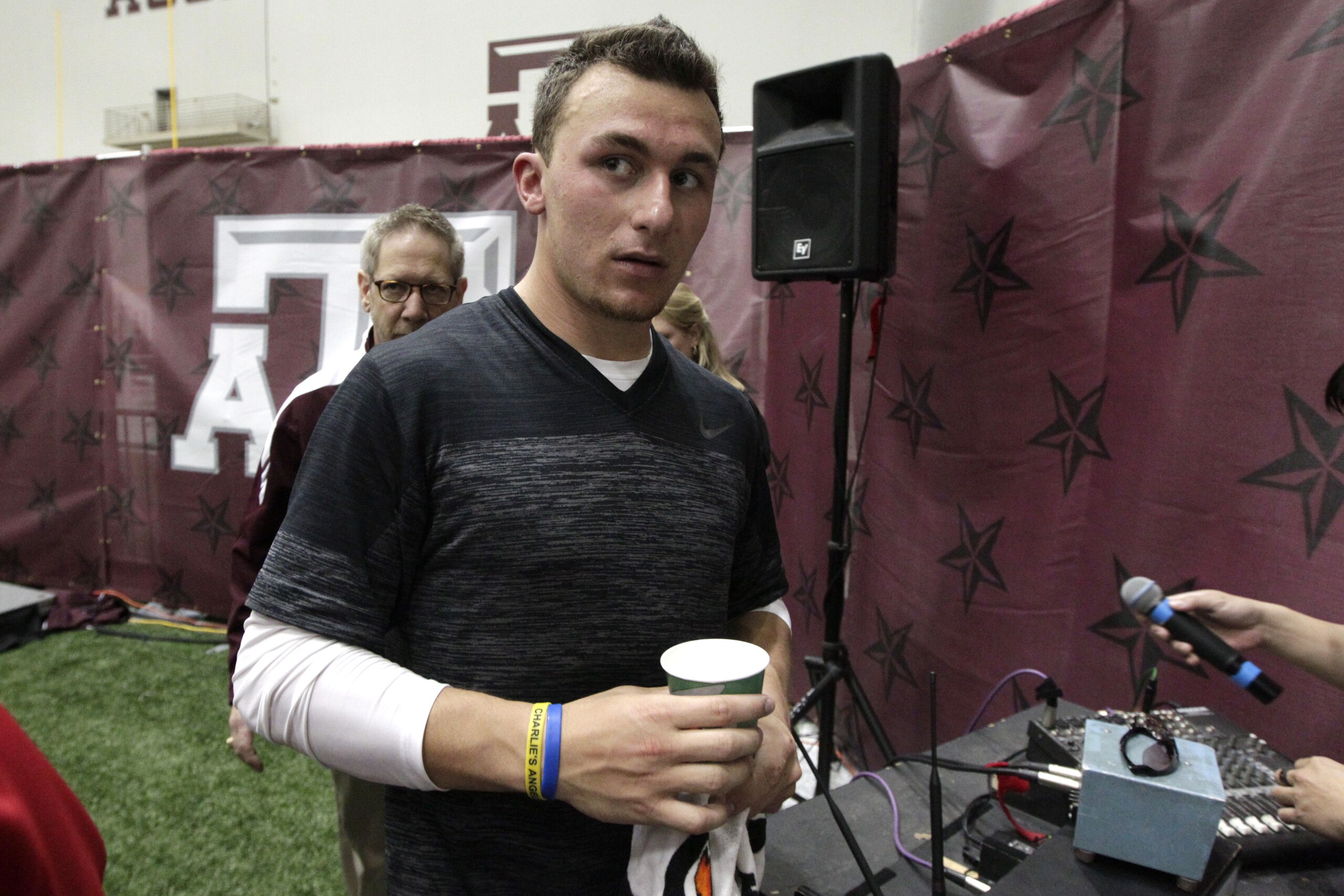 Texas A&M quarterback Johnny Manziel leaves the McFerrin Athletic Center after pro day for NFL football representatives in College Station, Texas, Thursday, March 27, 2014. (AP Photo/Patric Schneider)