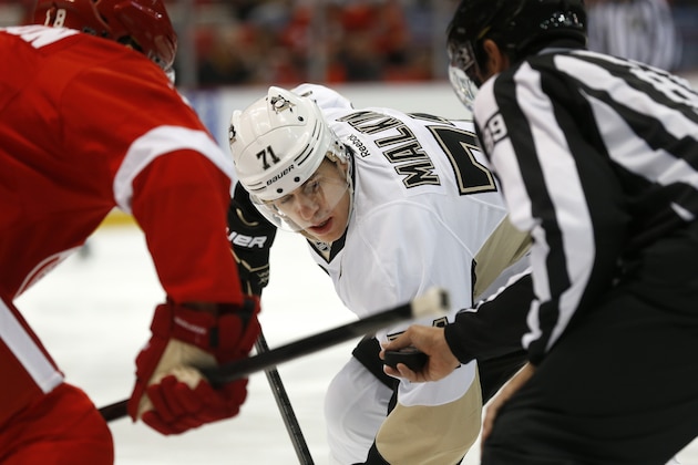 Pittsburgh Penguins center Evgeni Malkin (71) faces off against Detroit Red Wings center Joakim Andersson (18), of Sweden, in the first period of a NHL preseason hockey game in Detroit, Wednesday, Sept. 25, 2013. (AP Photo/Paul Sancya)