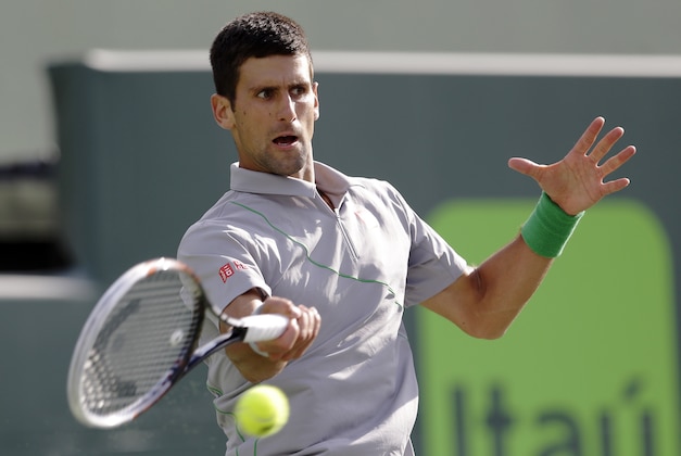 Novak Djokovic, of Serbia, returns to Andy Murray, of Great Britain, at the Sony Open Tennis tournament in Key Biscayne, Fla., Wednesday, March 26, 2014. (AP Photo/Alan Diaz)