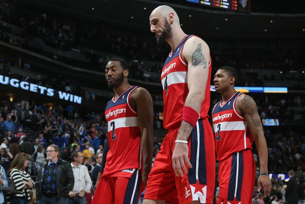 From left, Washington Wizards guard John Wall, center Marcin Gortat, of Poland, and guard Bradley Beal head to the locker room after the Denver Nuggets' 105-102 victory over the Wizards in an NBA basketball game in Denver on Sunday, March 23, 2014. (AP Photo/David Zalubowski)