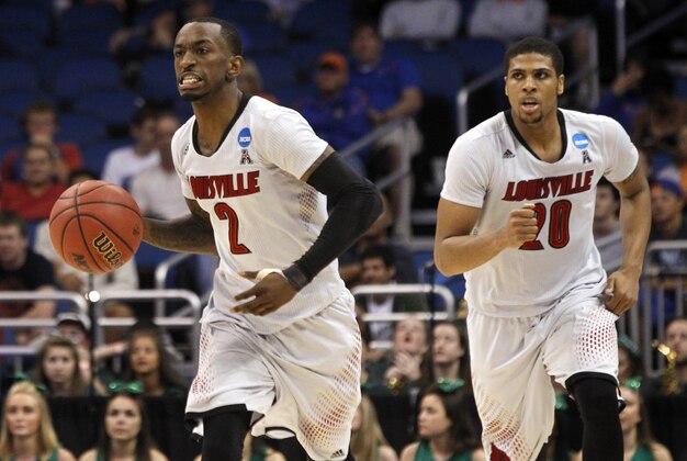 Mar 20, 2014; Orlando, FL, USA; Louisville Cardinals guard Russ Smith (2) brings the ball up the court against the Manhattan Jaspers during the second half of a men's college basketball game during the second round of the 2014 NCAA Tournament at Amway Center. Mandatory Credit: Kim Klement-USA TODAY Sports