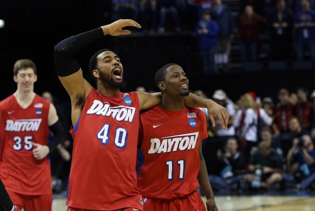 Mar 27, 2014; Memphis, TN, USA; Dayton Flyers forward/center Devon Scott (40) and Scoochie Smith (11) celebrate after defeating the Stanford Cardinal 82-72 in the semifinals of the south regional of the 2014 NCAA Mens Basketball Championship tournament at FedExForum. Mandatory Credit: Nelson Chenault-USA TODAY Sports