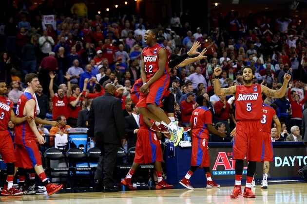 MEMPHIS, TN - MARCH 27: Kendall Pollard #22 and Devin Oliver #5 of the Dayton Flyers celebrate after defeating the Stanford Cardinal 82-72 in a regional semifinal of the 2014 NCAA Men's Basketball Tournament at the FedExForum on March 27, 2014 in Memphis, Tennessee.  (Photo by Streeter Lecka/Getty Images)