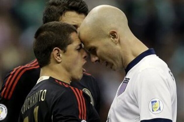 Mexico's Javier Hernandez, left, and United States' Michael Bradley confront each other at the end of a 2014 World Cup qualifying match at the Aztec stadium in Mexico City, Tuesday, March 26, 2013. The match ended 0-0. (AP Photo/Eduardo Verdugo)