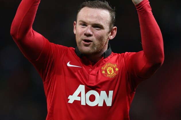 Manchester United's Wayne Rooney celebrates after his team's 3-0 Champions League last 16 second leg soccer match win against Olympiacos at Old Trafford Stadium, Manchester, England, Wednesday, March 19, 2014. (AP Photo/Jon Super)