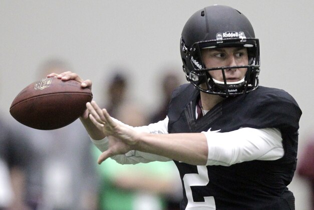 Texas A&M quarterback Johnny Manziel passes the ball during a drill at pro day for NFL football representatives in College Station, Texas, Thursday, March 27, 2014. (AP Photo/Patric Schneider)