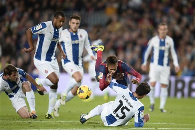 FC Barcelona's Neymar, from Brazil, falls over Espanyol's Hector Moreno, on the ground, during a Spanish La Liga soccer match at the Camp Nou stadium in Barcelona, Spain, Friday, Nov. 1, 2013. (AP Photo/Manu Fernandez)