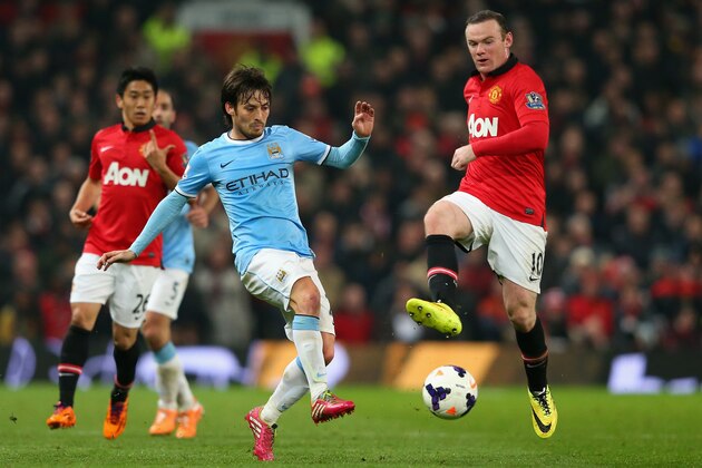 MANCHESTER, ENGLAND - MARCH 25:  David Silva of Manchester City competes with Wayne Rooney of Manchester United during the Barclays Premier League match between Manchester United and Manchester City at Old Trafford on March 25, 2014 in Manchester, England.  (Photo by Alex Livesey/Getty Images)