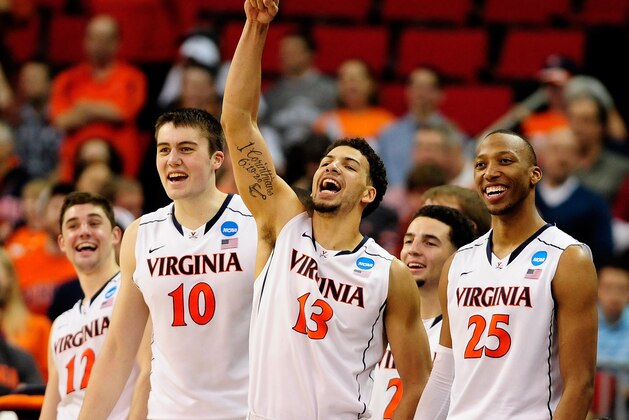 RALEIGH, NC - MARCH 23:  Joe Harris #12, Mike Tobey #10, Anthony Gill #13 and Akil Mitchell #25 of the Virginia Cavaliers react late in the game against the Memphis Tigers during the third round of the 2014 NCAA Men's Basketball Tournament at PNC Arena on March 23, 2014 in Raleigh, North Carolina.  (Photo by Grant Halverson/Getty Images)