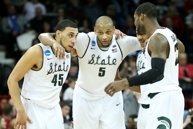SPOKANE, WA - MARCH 22:  Denzel Valentine #45 Adreian Payne #5, Keith Appling #11 and Branden Dawson #22 of the Michigan State Spartans celebrate in the second half of their 80 to 73 win over the Harvard Crimson during the Third Round of the 2014 NCAA Basketball Tournament at Spokane Veterans Memorial Arena on March 22, 2014 in Spokane, Washington.  (Photo by Stephen Dunn/Getty Images)
