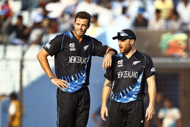 New Zealand's Tim Southee, left, stands with his team captain Brendon McCullum after taking the wicket of South Africa's Albie Morke during their ICC Twenty20 Cricket World Cup match in Chittagong, Bangladesh, Monday, March 24, 2014. (AP Photo/A.M. Ahad)