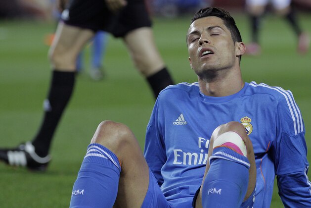 Real Madrid's Cristiano Ronaldo from Portugal reacts during a La Liga soccer match against Sevilla at the Ramon Sanchez Pizjuan stadium, in Seville, Spain on Wednesday, March 26, 2014. (AP Photo/Angel Fernandez)