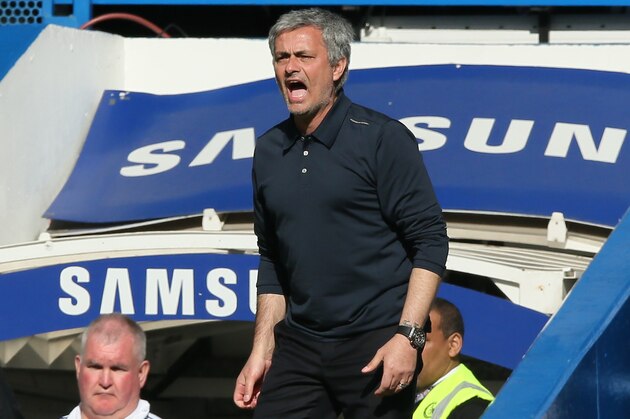 Chelsea's manager Jose Mourinho watches his team play during their English Premier League soccer match between Chelsea and Arsenal at Stamford Bridge stadium in London, Saturday, March  22, 2014. (AP Photo/Alastair Grant)