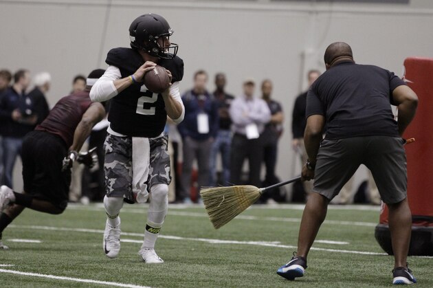 Texas A&M quarterback Johnny Manziel passes the ball during a drill at pro day for NFL football representatives in College Station, Texas, Thursday, March 27, 2014. (AP Photo/Patric Schneider)