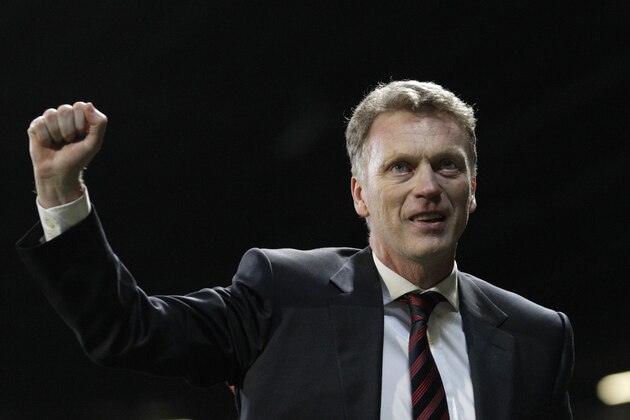Manchester United manager David Moyes celebrates after his team's 3-0 Champions League last 16 second leg soccer match win against Olympiacos at Old Trafford Stadium, Manchester, England, Wednesday, March 19, 2014. (AP Photo/Jon Super)