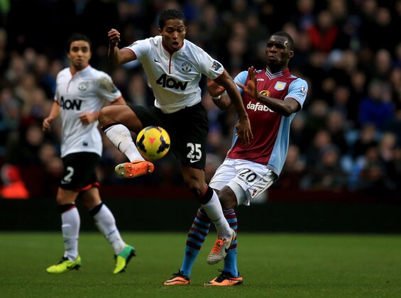 BIRMINGHAM, ENGLAND - DECEMBER 15:  Luis Antonio Valencia of Manchester United holds off the challenge of Christian Benteke of Aston Villa during the Barclays Premier League match between Aston Villa and Manchester United at Villa Park on December 15, 2013 in Birmingham, England. (Photo by Richard Heathcote/Getty Images)