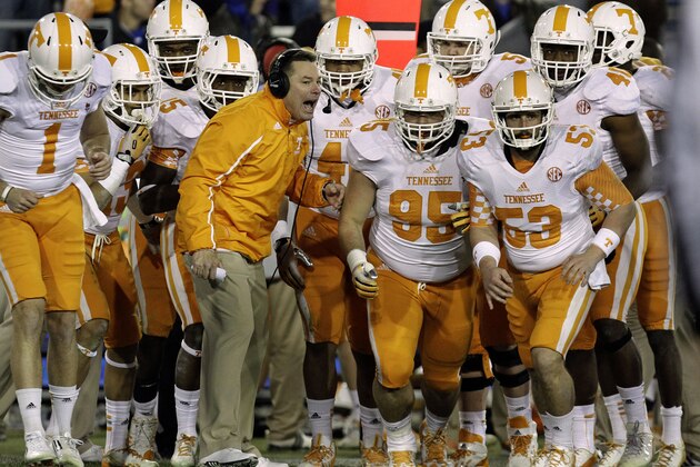 Tennessee coach Butch Jones, center, sends his team ontp the field in the fourth quarter against Kentucky in an NCAA college football game in Lexington, Ky., Saturday, Nov. 30, 2013. Tennessee won 27-14. (AP Photo/Garry Jones)