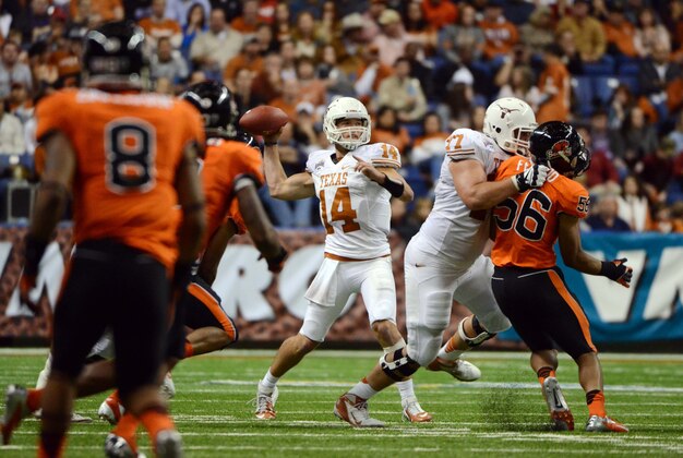 Dec 29, 2012; San Antonio, TX, USA; Texas Longhorns quarterback David Ash (14) passes the ball against the Oregon State Beavers during the second half of the Alamo Bowl at the Alamodome. Texas beat Oregon State 31-27. Mandatory Credit: Brendan Maloney-USA TODAY Sports