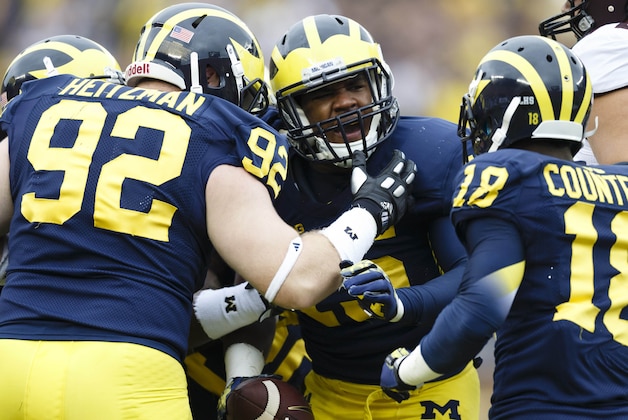Oct 5, 2013; Ann Arbor, MI, USA; Michigan Wolverines linebacker James Ross III (15) receives congratulations from defensive end Keith Heitzman (92) and defensive back Blake Countess (18) after  he recovers a fumble in the first quarter against the Minnesota Golden Gophers at Michigan Stadium. Mandatory Credit: Rick Osentoski-USA TODAY Sports