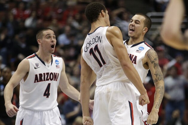 Arizona guard Gabe York, right, celebrates with T.J. McConnell (4) and Aaron Gordon (11) during the second half against San Diego State in a regional semifinal of the NCAA men's college basketball tournament, Thursday, March 27, 2014, in Anaheim, Calif. (AP Photo/Jae C. Hong)