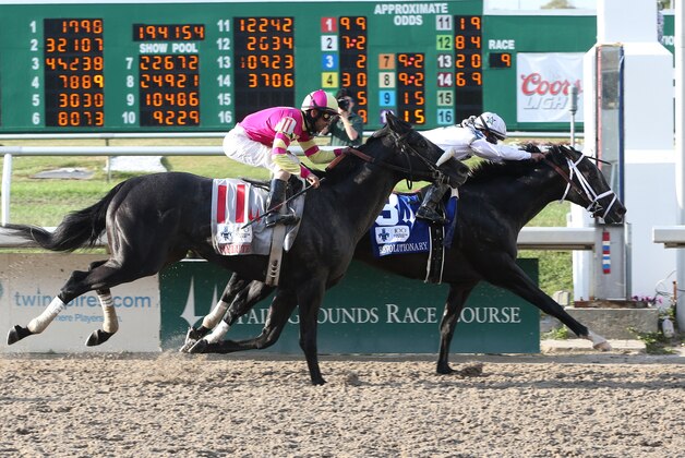 In this photo provided by Fair Grounds Race Course, Revolutionary with Javier Castellano aboard pulls ahead of Mylute to capture the 100th running of the $1,000,000 Grade II Louisiana Derby horse race at Fair Grounds in New Orleans, Saturday, March 30, 2013. (AP Photo/Fair Grounds Race Course/Hodges Photography, Lou Hodges, Jr.)