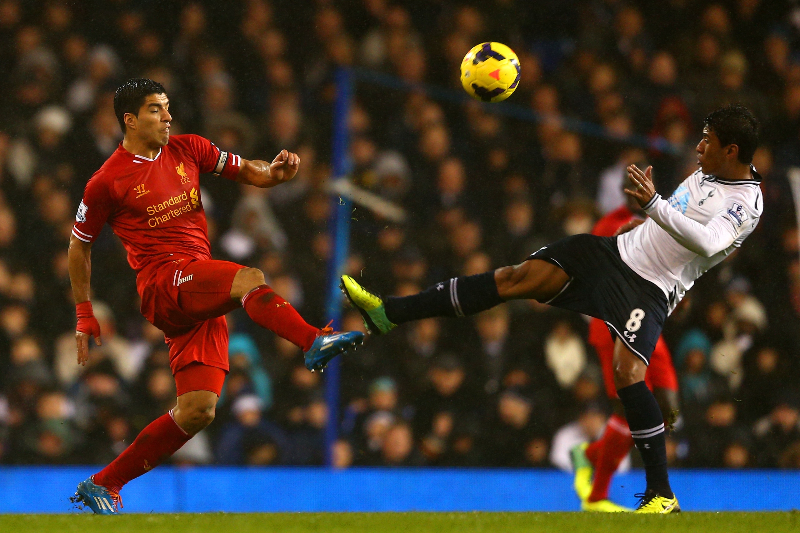LONDON, ENGLAND - DECEMBER 15:  Paulinho of Tottenham Hotspur fouls Luis Suarez of Liverpool during the Barclays Premier League match between Tottenham Hotspur and Liverpool at White Hart Lane on December 15, 2013 in London, England. (Photo by Paul Gilham/Getty Images)