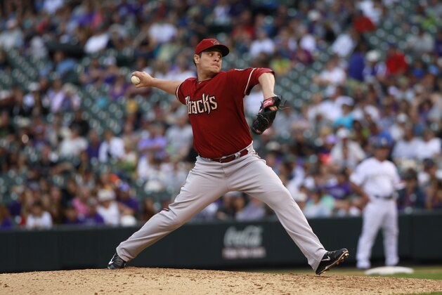 Arizona Diamondbacks relief pitcher David Hernandez works against the Colorado Rockies in the eighth inning of the Diamondbacks' 13-9 victory in a baseball game in Denver on Sunday, Sept. 22, 2013. (AP Photo/David Zalubowski)