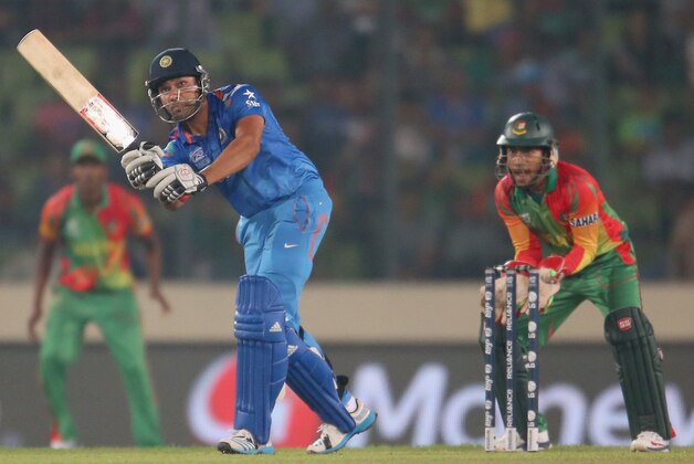 DHAKA, BANGLADESH - MARCH 28: Rohit Sharma of India bats as Mushfiqur Rahim of Bangladesh looks on during the ICC World Twenty20 Bangladesh 2014 match between Bangladesh and India at Sher-e-Bangla Mirpur Stadium on March 28, 2014 in Dhaka, Bangladesh. (Photo by Scott Barbour/Getty Images) DHAKA, BANGLADESH - MARCH 28: Rohit Sharma of India bats as Mushfiqur Rahim of Bangladesh looks on during the ICC World Twenty20 Bangladesh 2014 match between Bangladesh and India at Sher-e-Bangla Mirpur Stadium on March 28, 2014 in Dhaka, Bangladesh. (Photo by Scott Barbour/Getty Images)