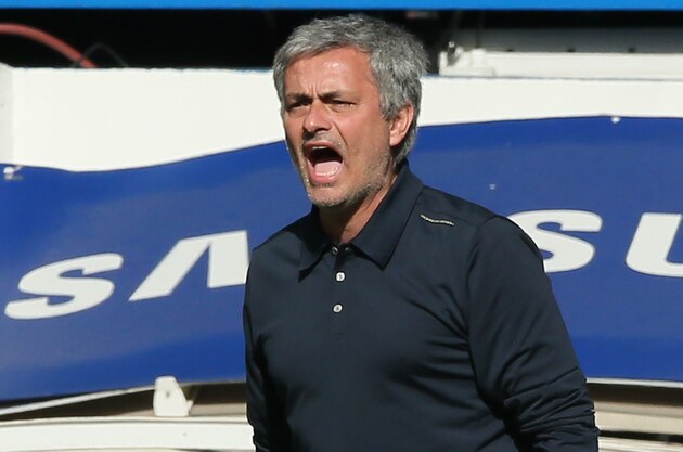 Chelsea's manager Jose Mourinho watches his team play during their English Premier League soccer match between Chelsea and Arsenal at Stamford Bridge stadium in London, Saturday, March  22, 2014. (AP Photo/Alastair Grant)