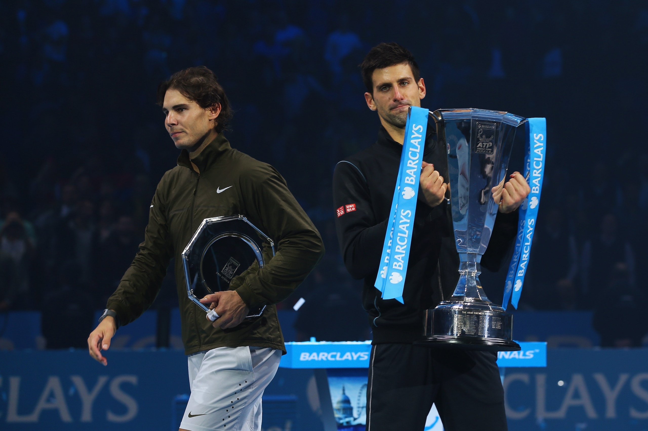 LONDON, ENGLAND - NOVEMBER 11:  Rafael Nadal (L) of Spain walks away as Novak Djokovic of Serbia holds the trophy after their men's singles final match during day eight of the Barclays ATP World Tour Finals at O2 Arena on November 11, 2013 in London, England.  (Photo by Clive Brunskill/Getty Images)
