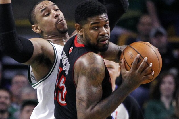 Toronto Raptors forward Amir Johnson (15) looks to pass against the defense of Boston Celtics center Jared Sullinger in the second half of an NBA basketball game in Boston, Wednesday, March 26, 2014. (AP Photo/Elise Amendola)