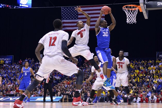 Mar 28, 2014; Indianapolis, IN, USA; Kentucky Wildcats forward Julius Randle (30) shoots against Louisville Cardinals guard Terry Rozier (0)  in the first half in the semifinals of the midwest regional of the 2014 NCAA Mens Basketball Championship tournament at Lucas Oil Stadium. Mandatory Credit: Bob Donnan-USA TODAY Sports