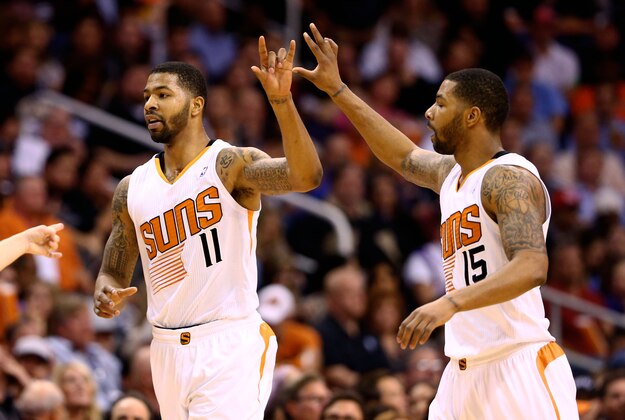 Jan 22, 2014; Phoenix, AZ, USA; Phoenix Suns forward Markieff Morris (left) celebrates a play with twin brother Marcus Morris against the Indiana Pacers in the first half at US Airways Center. Mandatory Credit: Mark J. Rebilas-USA TODAY Sports