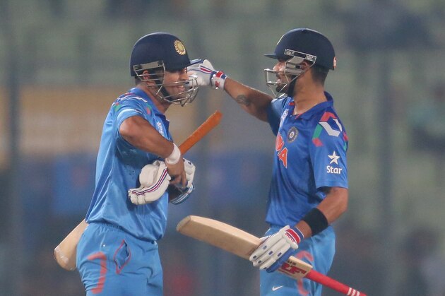 DHAKA, BANGLADESH - MARCH 28:  Virat Kohli and MS Dhoni of India embrace after winning the ICC World Twenty20 Bangladesh 2014 match between Bangladesh and India at Sher-e-Bangla Mirpur Stadium on March 28, 2014 in Dhaka, Bangladesh.  (Photo by Scott Barbour/Getty Images)