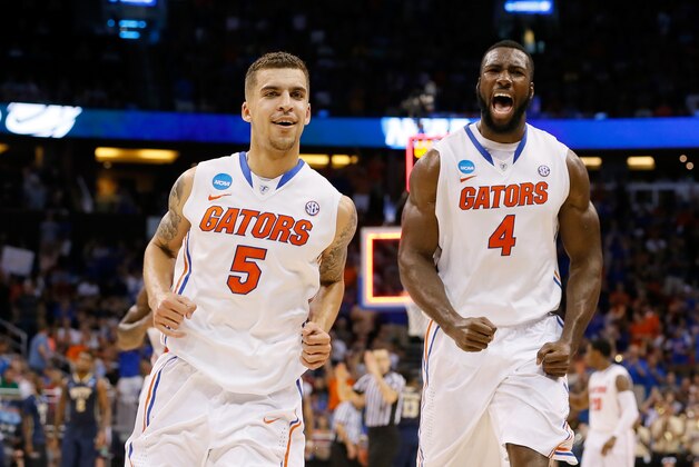 ORLANDO, FL - MARCH 22:  Scottie Wilbekin #5 and Patric Young #4 of the Florida Gators celebrate after Wilbekin makes a three-pointer to end the first half against the Pittsburgh Panthers during the third round of the 2014 NCAA Men's Basketball Tournament at Amway Center on March 22, 2014 in Orlando, Florida.  (Photo by Kevin C. Cox/Getty Images)