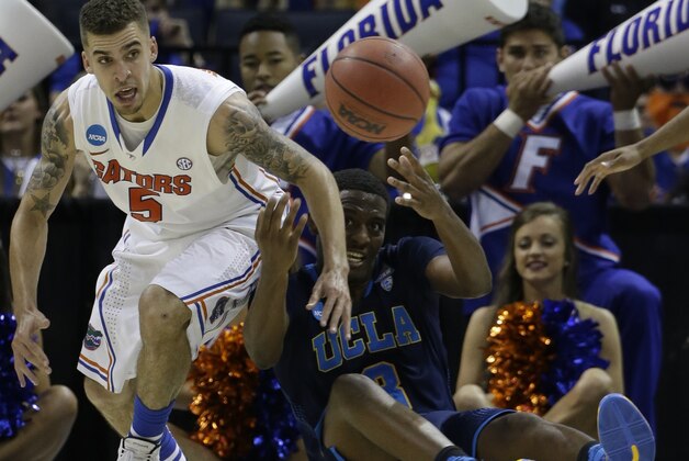 Florida guard Scottie Wilbekin (5) and UCLA guard Jordan Adams (3) vie for a loose ball during the second half in a regional semifinal game at the NCAA college basketball tournament, Thursday, March 27, 2014, in Memphis, Tenn. Florida won 79-68. (AP Photo/Mark Humphrey)