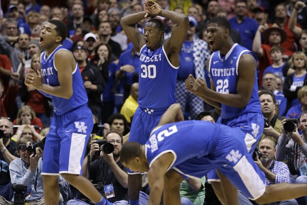 Kentucky's Andrew Harrison (5), Julius Randle (30), Alex Poythress (22) and Aaron Harrison (2) react to a call during the second half of an NCAA Midwest Regional semifinal college basketball tournament game against the Louisville Saturday, March 29, 2014, in Indianapolis. (AP Photo/David J. Phillip)